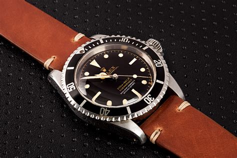 rolex submariner with leather strap.